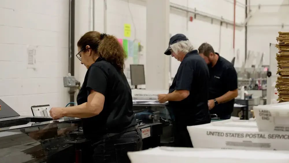 Heeter team members sorting direct mail collateral