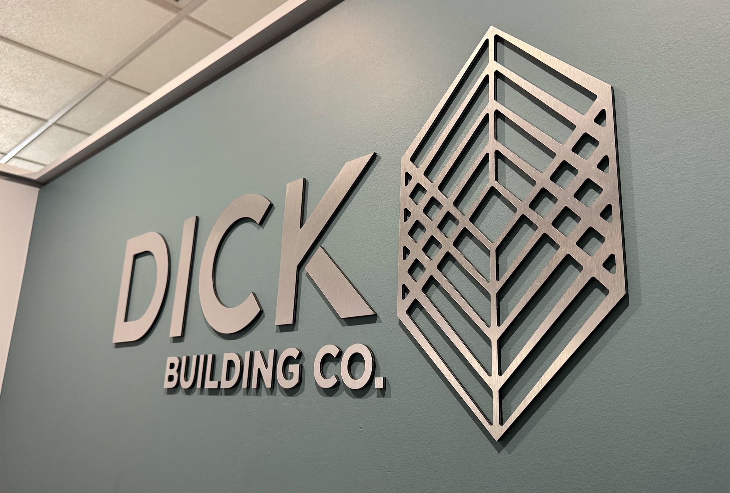 metal wall graphic with Dick Building Co logo