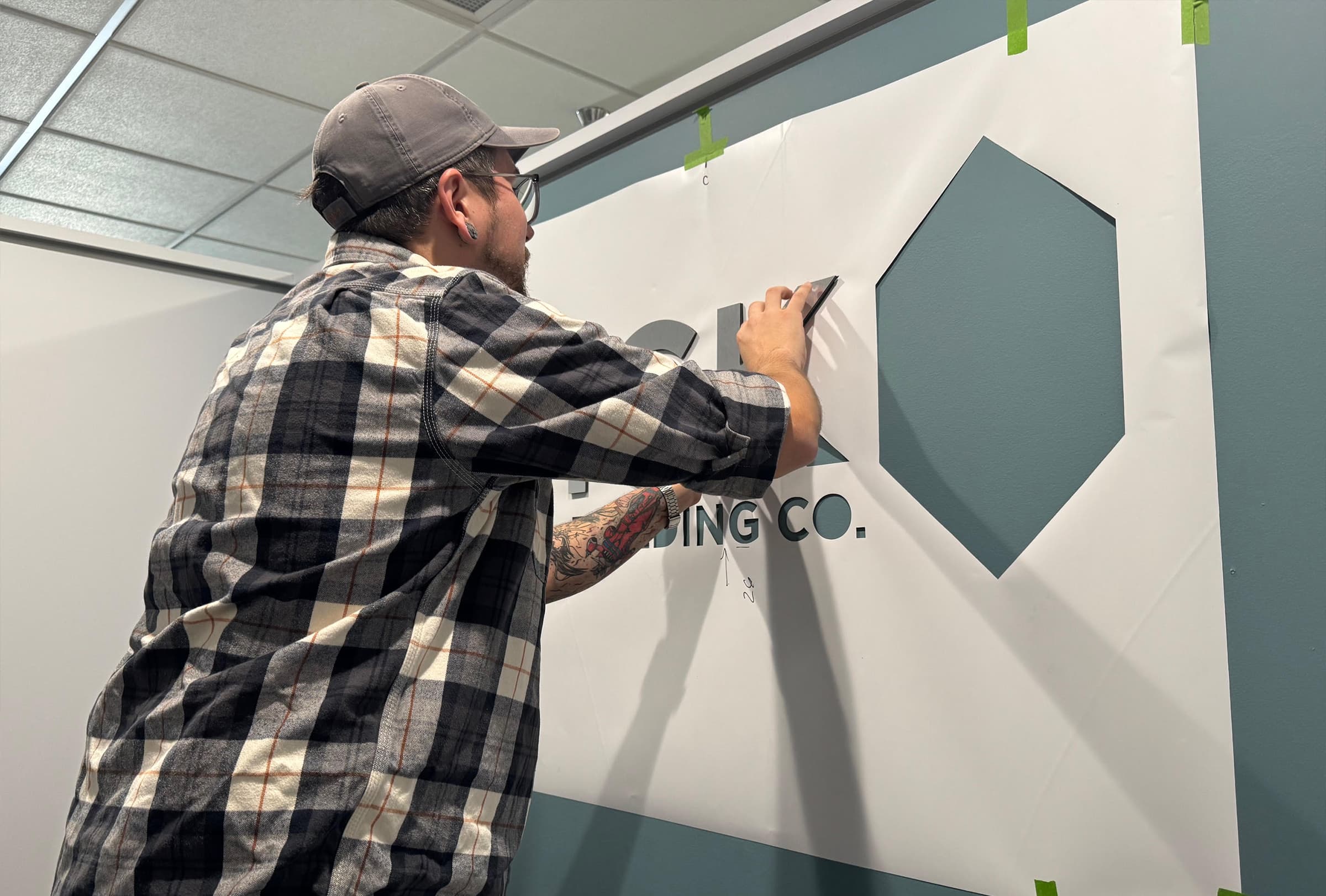 installation of metal Dick Building Co logo